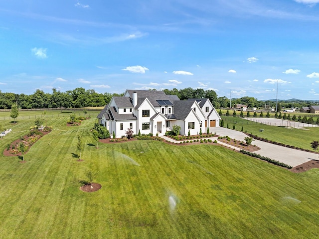 4720 Edwardian Trce, Franklin, TN 37067 - view of front facade featuring driveway, a front lawn, stucco siding, and solar panels