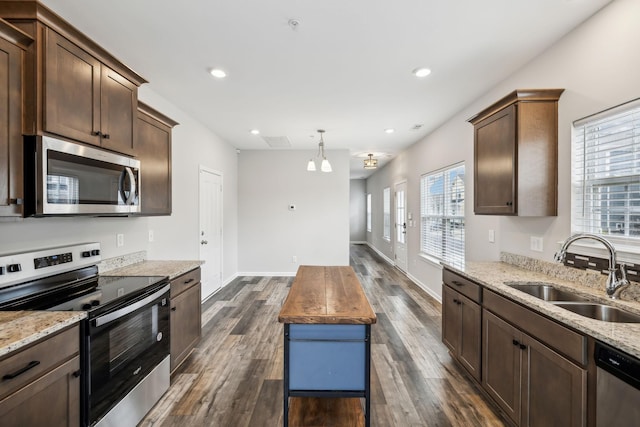 100 Bergen Dr, Spring Hill, TN 37174 - kitchen featuring appliances with stainless steel finishes, healthy amount of natural light, light stone countertops, dark wood-style floors, and recessed lighting