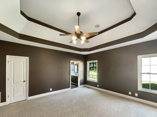 3624 Prestwicke Pl, Adams, TN 37010 - unfurnished room with a tray ceiling, carpet flooring, and a ceiling fan