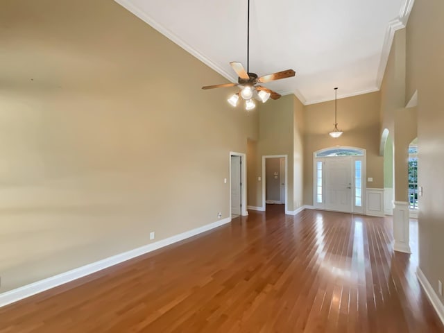 3624 Prestwicke Pl, Adams, TN 37010 - unfurnished living room with ornamental molding, a high ceiling, wood finished floors, a ceiling fan, and arched walkways