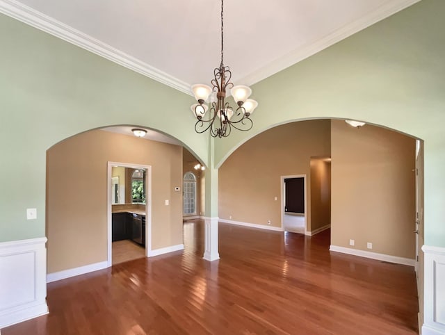 3624 Prestwicke Pl, Adams, TN 37010 - empty room featuring arched walkways, wood finished floors, crown molding, and a chandelier