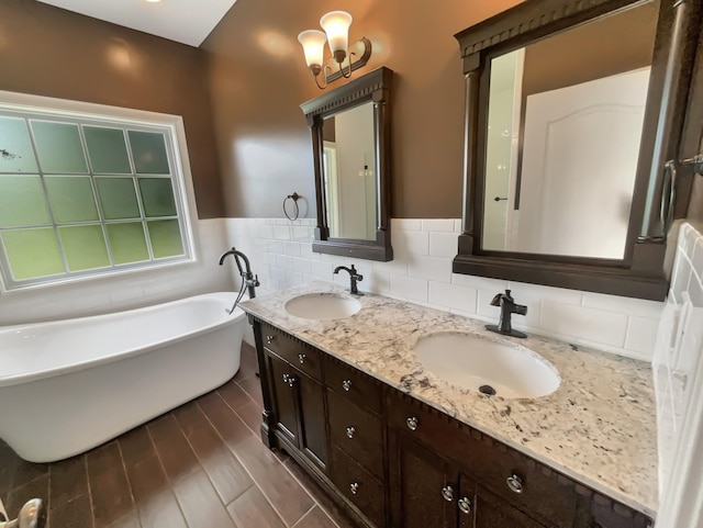 3624 Prestwicke Pl, Adams, TN 37010 - full bathroom with a soaking tub, double vanity, tile walls, and a wainscoted wall