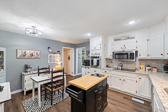 106 Mcfarlin Rd, Murfreesboro, TN 37130 - kitchen with stainless steel appliances, white cabinets, dark cabinetry, wood counters, and recessed lighting