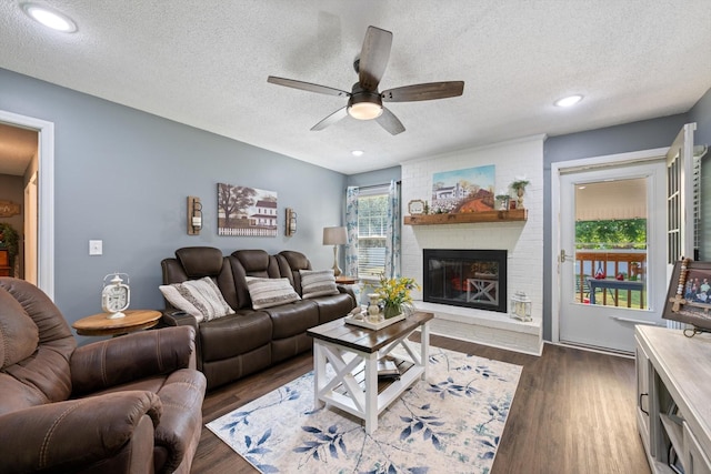 106 Mcfarlin Rd, Murfreesboro, TN 37130 - living area with a ceiling fan, a textured ceiling, dark wood-style flooring, and a fireplace