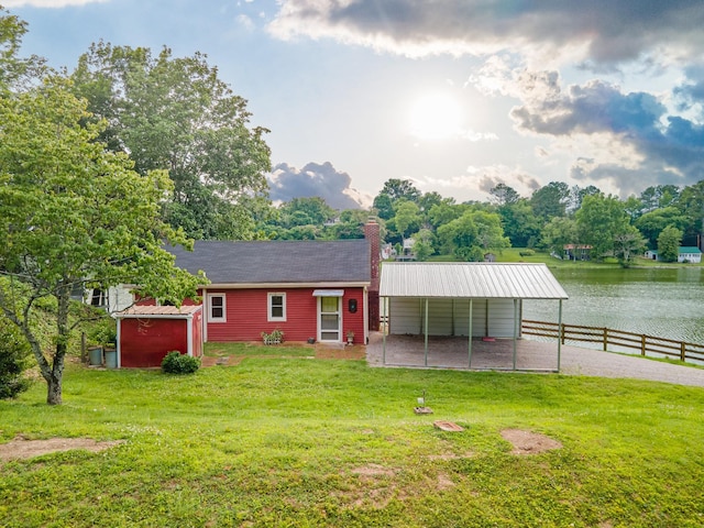 266 Clear Creek Cir, Pulaski, TN 38478 - view of front facade featuring a water view, a chimney, an outbuilding, and a carport