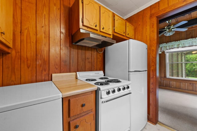 266 Clear Creek Cir, Pulaski, TN 38478 - kitchen with white appliances, wood walls, under cabinet range hood, light countertops, and brown cabinets