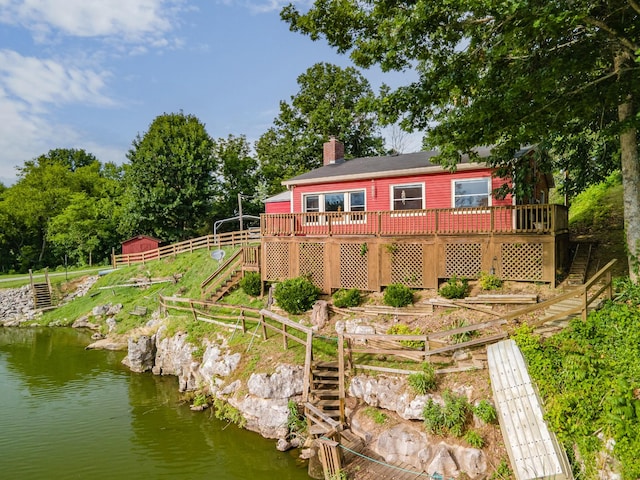 266 Clear Creek Cir, Pulaski, TN 38478 - rear view of house featuring stairs, a deck with water view, and a chimney