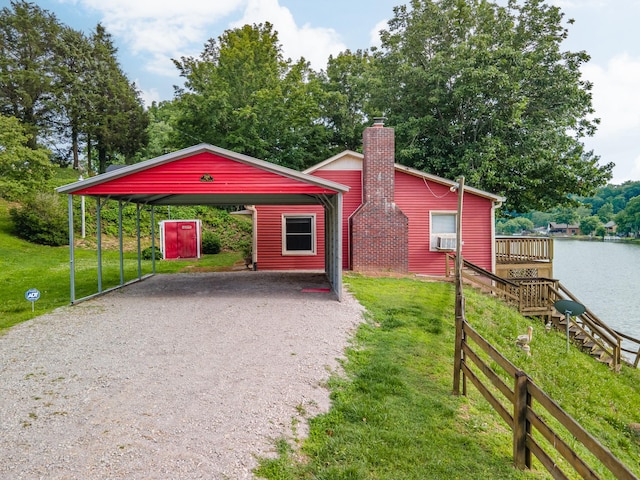 266 Clear Creek Cir, Pulaski, TN 38478 - view of front of property with driveway, a detached carport, a front yard, a deck with water view, and a chimney