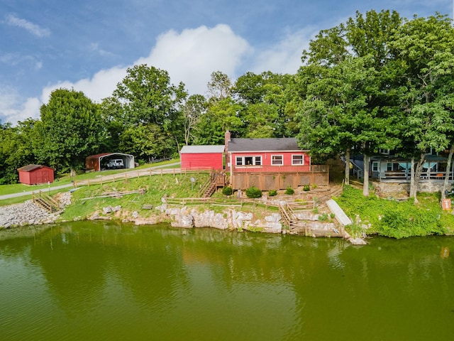 266 Clear Creek Cir, Pulaski, TN 38478 - rear view of house with stairway, a carport, a storage unit, and a deck with water view