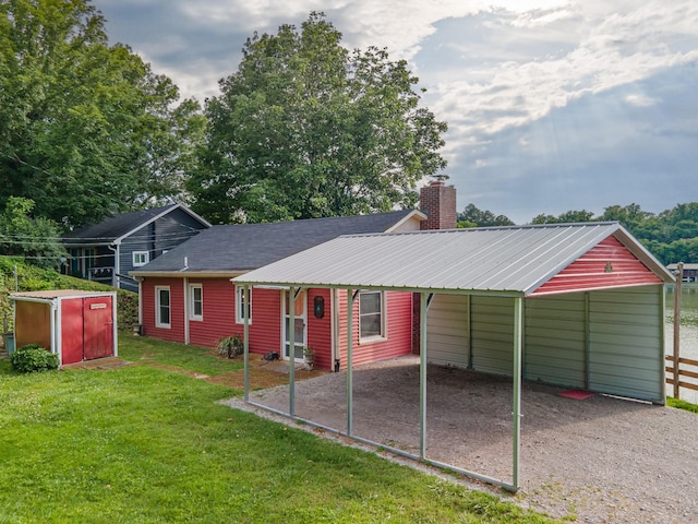 266 Clear Creek Cir, Pulaski, TN 38478 - rear view of property with gravel driveway, a yard, a detached carport, a chimney, and a storage unit