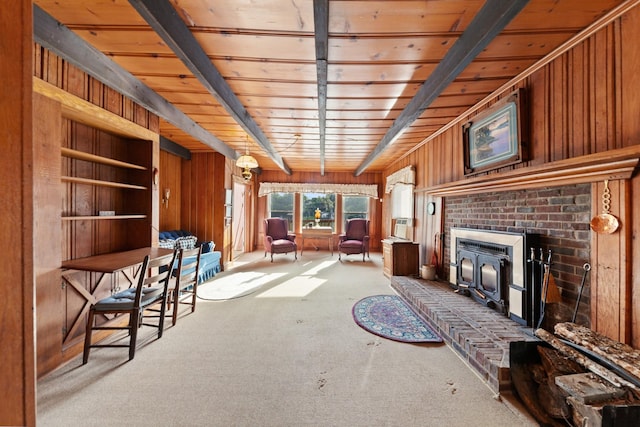 266 Clear Creek Cir, Pulaski, TN 38478 - unfurnished room featuring carpet flooring, wooden walls, a wood ceiling with exposed beams, and a brick fireplace