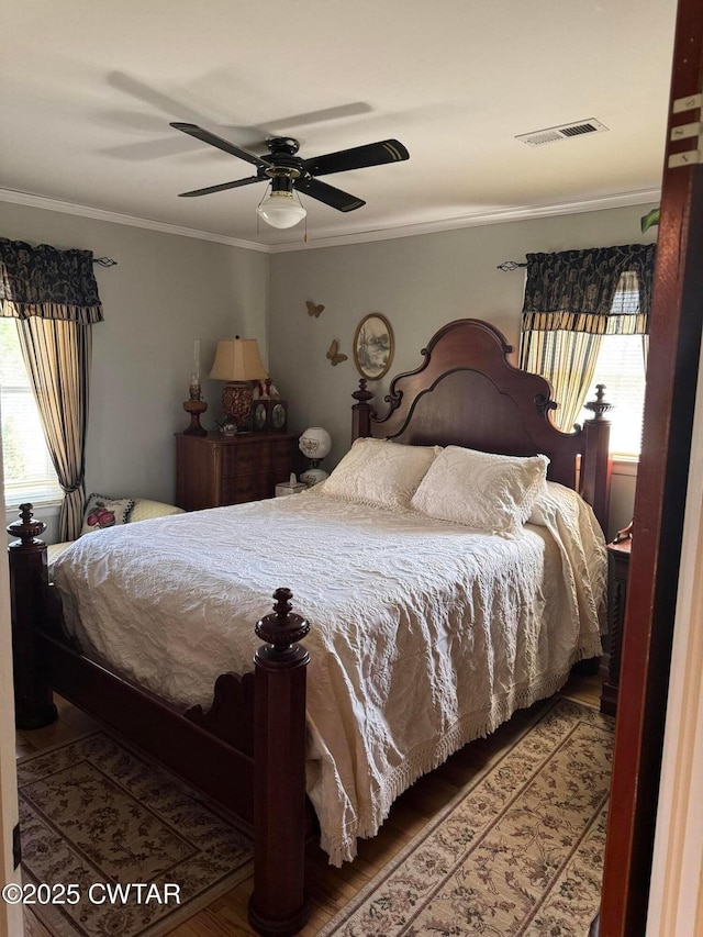 917 Columbia Ave, Centerville, TN 37033 - bedroom featuring multiple windows, crown molding, wood finished floors, and a ceiling fan