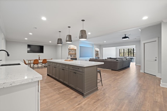 2996 S Rutland Rd, Mount Juliet, TN 37122 - kitchen with gray cabinetry, ornamental molding, a kitchen island, recessed lighting, and light wood-style floors