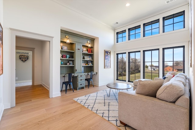 2996 S Rutland Rd, Mount Juliet, TN 37122 - living area with crown molding, light wood-style floors, built in shelves, an office area, and recessed lighting