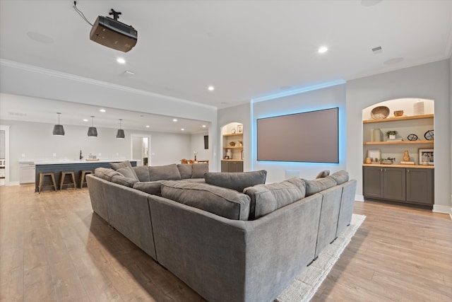 2996 S Rutland Rd, Mount Juliet, TN 37122 - living area with crown molding, light wood-style flooring, built in features, bar with sink, and recessed lighting