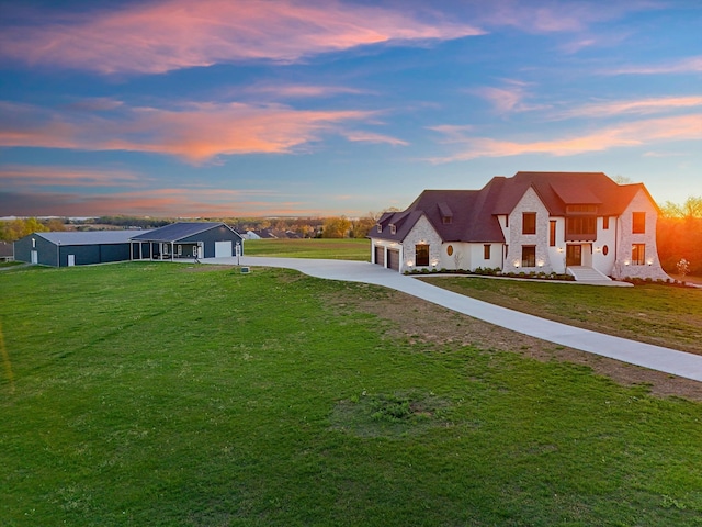 2996 S Rutland Rd, Mount Juliet, TN 37122 - yard at dusk with concrete driveway, a lawn, and an attached garage