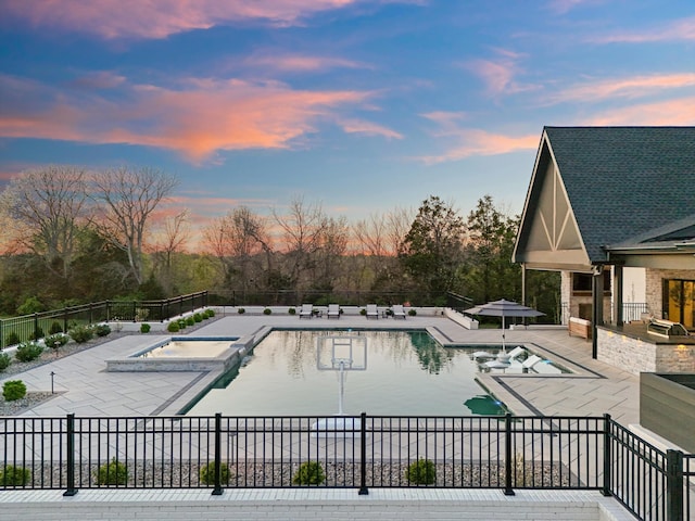 2996 S Rutland Rd, Mount Juliet, TN 37122 - pool at dusk featuring a patio area, an in-ground hot tub, and a community pool
