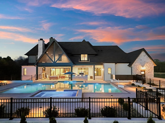 2996 S Rutland Rd, Mount Juliet, TN 37122 - pool at dusk with a patio area, a pool with connected hot tub, and an outdoor living space