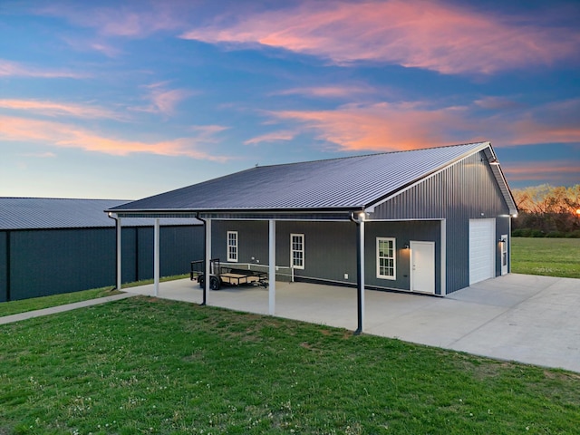 2996 S Rutland Rd, Mount Juliet, TN 37122 - back of property at dusk featuring a yard, a metal roof, a patio area, and concrete driveway