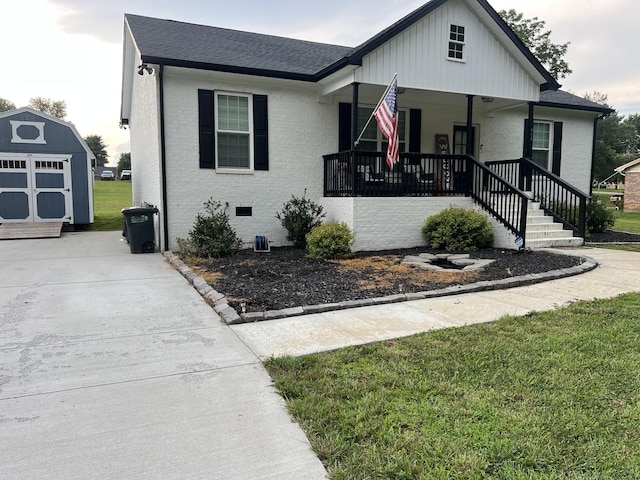 484 Royal Dr, Rock Island, TN 38581 - view of front of home featuring a storage shed, a porch, brick siding, driveway, and a shingled roof