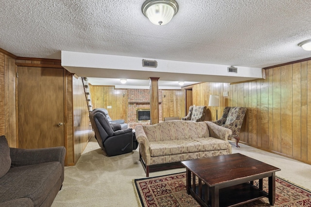 2604 Forest View Dr, Antioch, TN 37013 - living area featuring light colored carpet, wooden walls, a textured ceiling, and a fireplace