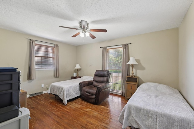 2604 Forest View Dr, Antioch, TN 37013 - bedroom with multiple windows, wood finished floors, a ceiling fan, and a textured ceiling