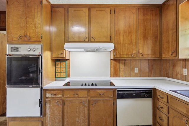 2604 Forest View Dr, Antioch, TN 37013 - kitchen with dishwasher, black electric cooktop, under cabinet range hood, double wall oven, and brown cabinets