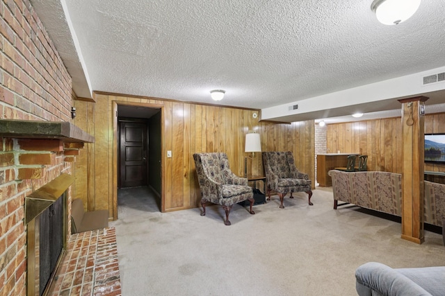 2604 Forest View Dr, Antioch, TN 37013 - carpeted living area featuring wooden walls, a fireplace, and a textured ceiling