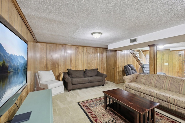 2604 Forest View Dr, Antioch, TN 37013 - carpeted living area featuring stairway, a textured ceiling, and wooden walls