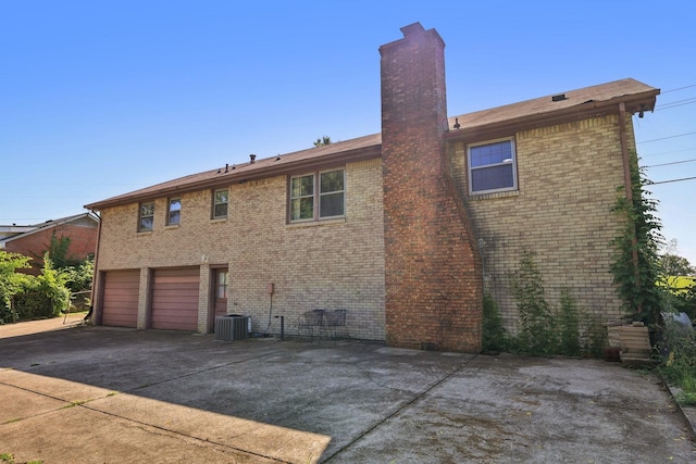 2604 Forest View Dr, Antioch, TN 37013 - back of property featuring driveway, a chimney, brick siding, and a garage