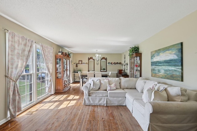 2604 Forest View Dr, Antioch, TN 37013 - living room featuring a chandelier, wood finished floors, and a textured ceiling