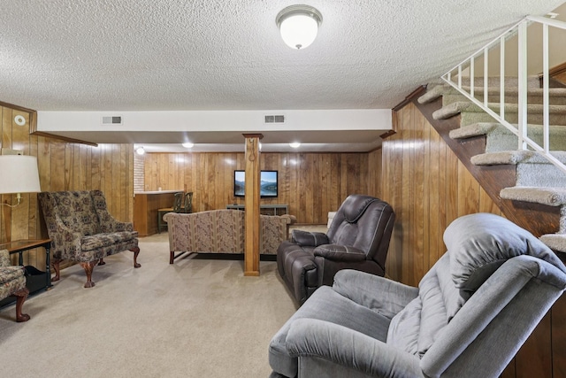 2604 Forest View Dr, Antioch, TN 37013 - living room featuring wood walls, light carpet, a textured ceiling, and stairway