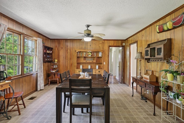2604 Forest View Dr, Antioch, TN 37013 - dining room with wood walls, ornamental molding, ceiling fan, and a textured ceiling
