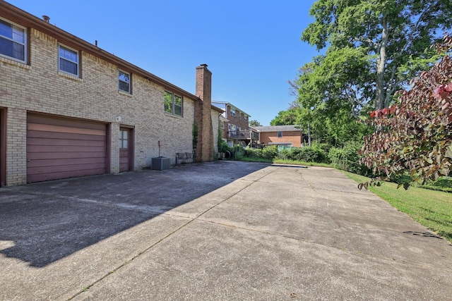 2604 Forest View Dr, Antioch, TN 37013 - view of property exterior with a chimney, driveway, brick siding, and a garage