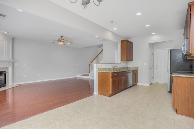 446 Lazy Creek Ln, Nashville, TN 37211 - kitchen with appliances with stainless steel finishes, open floor plan, a ceiling fan, recessed lighting, and a fireplace with flush hearth