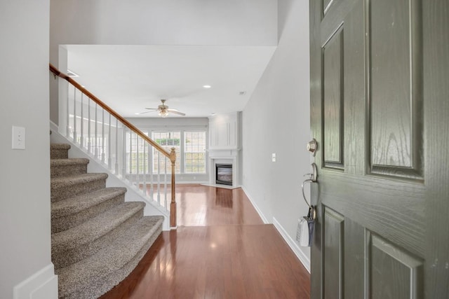 446 Lazy Creek Ln, Nashville, TN 37211 - foyer featuring dark wood-style flooring, a glass covered fireplace, a ceiling fan, stairway, and recessed lighting