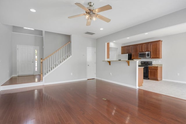 446 Lazy Creek Ln, Nashville, TN 37211 - unfurnished living room with light wood finished floors, stairs, a ceiling fan, and recessed lighting