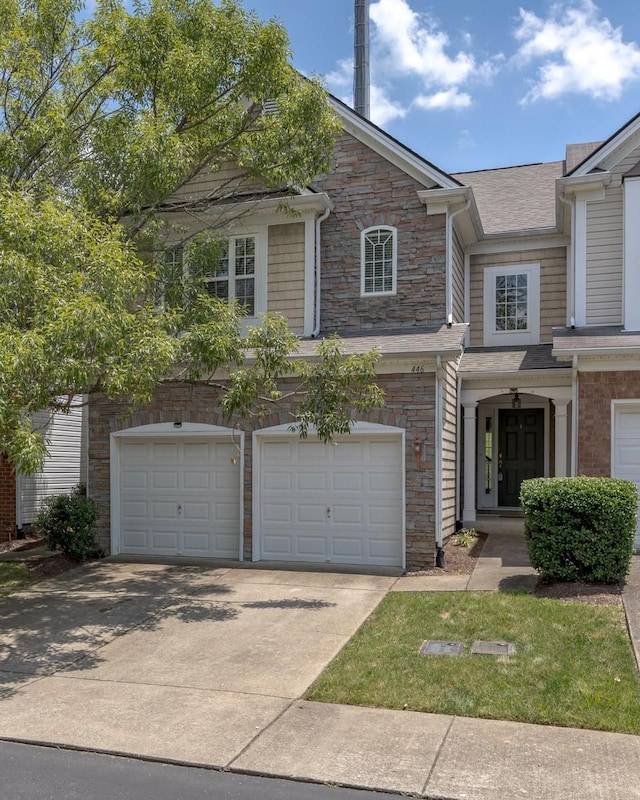 446 Lazy Creek Ln, Nashville, TN 37211 - view of front of house with an attached garage, stone siding, driveway, and roof with shingles