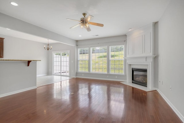 446 Lazy Creek Ln, Nashville, TN 37211 - unfurnished living room featuring a fireplace, a chandelier, a ceiling fan, wood finished floors, and recessed lighting