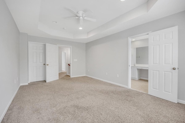 446 Lazy Creek Ln, Nashville, TN 37211 - unfurnished bedroom featuring a tray ceiling, light carpet, recessed lighting, ensuite bathroom, and ceiling fan