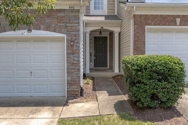 446 Lazy Creek Ln, Nashville, TN 37211 - view of exterior entry featuring a garage, driveway, and brick siding