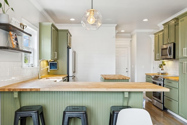 2819 Silver Springs Ct, Murfreesboro, TN 37128 - kitchen with green cabinets, butcher block counters, appliances with stainless steel finishes, decorative backsplash, and ornamental molding