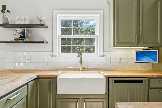 2819 Silver Springs Ct, Murfreesboro, TN 37128 - kitchen with green cabinets, wood counters, dishwashing machine, and tasteful backsplash