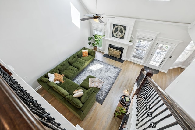 2819 Silver Springs Ct, Murfreesboro, TN 37128 - living room featuring a fireplace with flush hearth, ceiling fan, plenty of natural light, wood finished floors, and high vaulted ceiling
