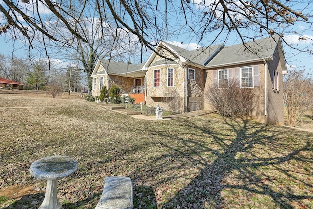 311 Downs Rd, Cumberland City, TN 37050 - view of property exterior featuring brick siding, stone siding, and a lawn