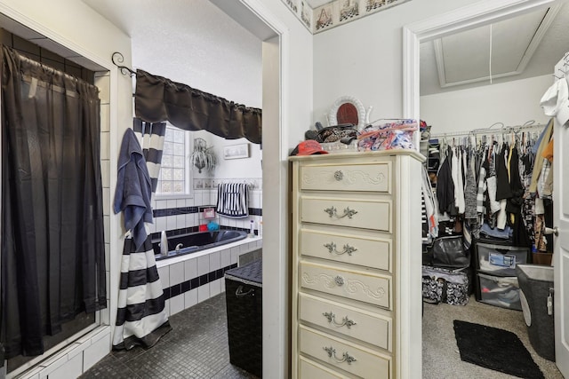 311 Downs Rd, Cumberland City, TN 37050 - spacious closet with attic access and dark tile patterned floors