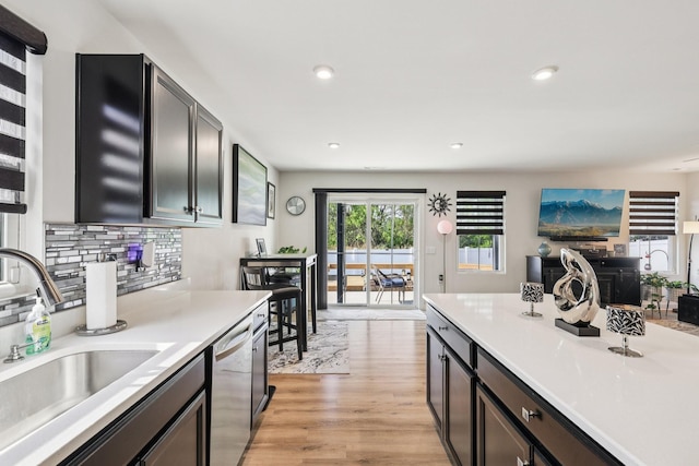2617 Thornton Grove Blvd, Nashville, TN 37207 - kitchen with dishwasher, light countertops, light wood-type flooring, backsplash, and recessed lighting