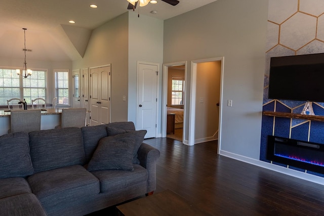 1452 Precept Dr, Murfreesboro, TN 37129 - living area featuring dark wood finished floors, a ceiling fan, a chandelier, a tiled fireplace, and high vaulted ceiling