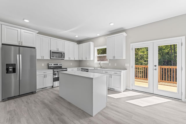 4315 Surji Cir, Centerville, TN 37033 - kitchen featuring stainless steel appliances, light countertops, a center island, light wood-type flooring, and french doors