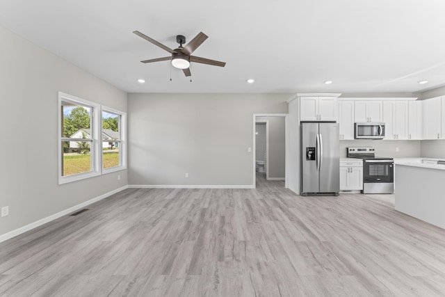 4315 Surji Cir, Centerville, TN 37033 - kitchen with stainless steel appliances, open floor plan, light countertops, a ceiling fan, and light wood finished floors